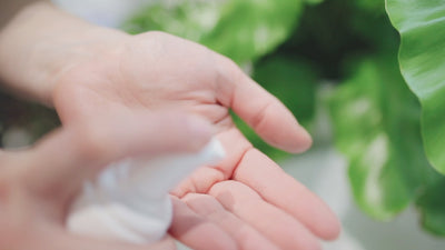 A woman applying lotion to her hand.